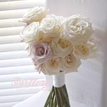 Modern bridal bouquet of tiered white and blush roses